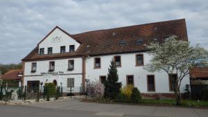 ein weißes Gebäude mit braunem Dach in der Unterkunft Landhotel Garni Knittelsheimer Mühle in Knittelsheim
