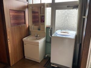a small bathroom with a sink and a toilet at Oita City Vacation Condominium in Oita +48 photos