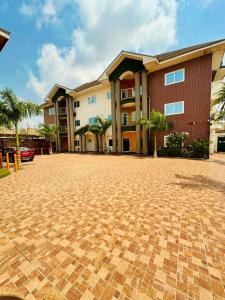 a brick parking lot in front of a building at Golden Crystal Hotel in Accra