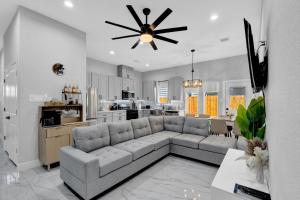 a living room with a couch and a kitchen at 10 Mins from NRG 3BR 3BA in Houston