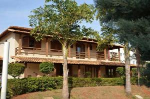 a large house with trees in front of it at Castelo da Lagoa in Lagoa Santa