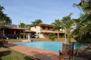 a swimming pool in front of a house at Castelo da Lagoa in Lagoa Santa