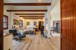 a living room with a couch and a table at Beachfront villa with direct access -Private pool & Zen Area in Quartu SantʼElena