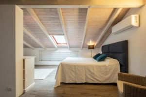 a bedroom with a large bed in a attic at Beachfront villa with direct access -Private pool & Zen Area in Quartu SantʼElena +52 photos