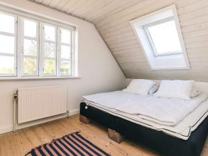 a small bedroom with a bed in a attic at Unique Coastal Retreat - By Traum Ferienwohnungen in Hadsund