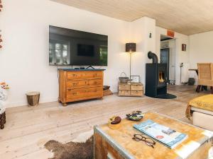 a living room with a couch and a fireplace at Unique Coastal Retreat - By Traum Ferienwohnungen in Hadsund +17 photos