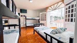 a dorm room with two bunk beds and a window at Hotel Santiago de Tolú in Santiago +56 photos