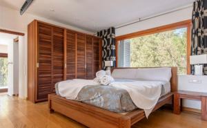 Un dormitorio con una cama grande y una ventana grande. en Villa cala tarida, en Cala Tarida 39 fotos más