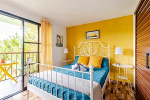 a bedroom with a bed and a balcony at Altos de Chulavista Constanza in Constanza