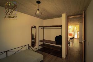 a bedroom with a bed and a mirror on the wall at Cabin-style apartment - Anpage in Puente de las Cuevas