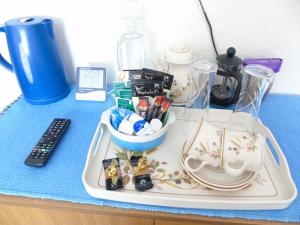 a table with a tray of food and a remote control at Jomarnic B&B in Lossiemouth