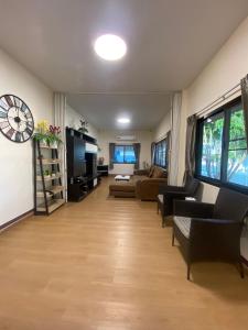 a living room with a couch and a table at Pool Smile Villa in Bangsaen