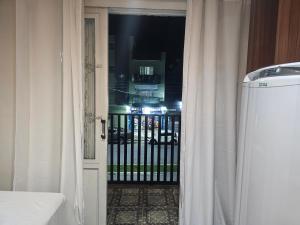 an open door to a balcony with a gate at Quarto Casal Aparecida-SP in Aparecida