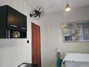 a bedroom with a bed and a clock on the wall at Quarto Casal Aparecida-SP in Aparecida +3 photos
