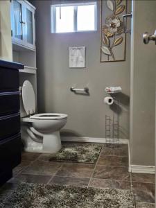 a bathroom with a toilet and a shower with a window at spare private luxury room in Pasco