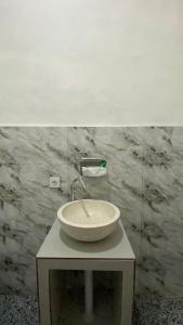 a white sink on a table in a bathroom at Lake Side Retreat & hot spring in Kubupenlokan +12 photos