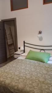 a bedroom with a green pillow on a bed at Comeacasa in Salerno +31 photos