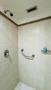 a shower in a bathroom with a shower head at Flat aconchegante in Brasilia +1 photo