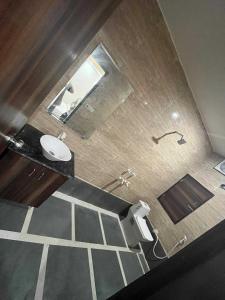 a bathroom with a sink and a toilet in it at Hotel O Yaduvanshi in Ballabgarh