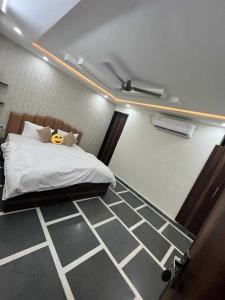 a bedroom with a bed with a yellow face on it at Hotel O Yaduvanshi in Ballabgarh +11 photos