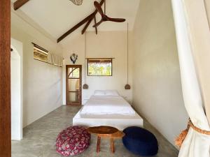a bedroom with a bed and a table at Villa Jivanaya in Isda Islet