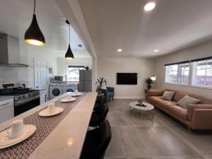 a kitchen and living room with a table and a couch at Gated & remodeled 2b2b house 3373 in Baldwin Park