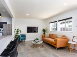 a living room with a couch and a table at Gated & remodeled 2b2b house 3373 in Baldwin Park