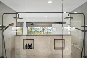 a bathroom with a shower with glass walls at Beautiful Balook - 3 Bedroom Beach House in Lauderdale +63 photos