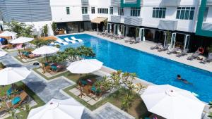 an overhead view of a pool at a hotel with umbrellas at The Bayou Hotel Langkawi in Pantai Cenang
