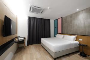 a hotel room with a bed and a tv at The Bayou Hotel Langkawi in Pantai Cenang