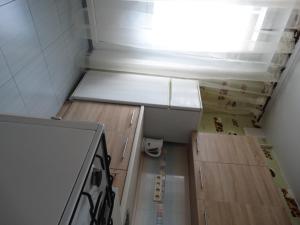 a small kitchen with a stove and some boxes at InnDays on Sportivnaya in Moscow