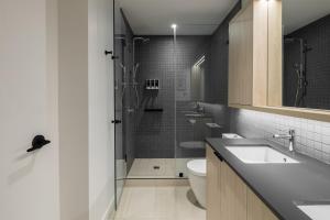 a bathroom with a shower and a sink and a toilet at Smithe House in Vancouver +98 photos