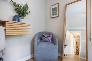 a blue chair with a red bow pillow in a room at Lake Oliver Cottage Near Fort Benning & Downtown Columbus in Columbus