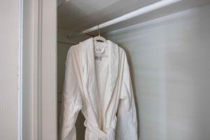 a white sweater hanging in a closet at Lake Oliver Cottage Near Fort Benning & Downtown Columbus in Columbus +47 photos