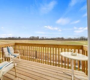 a wooden deck with a table and chairs on it at Cambridge Luxury by Ravine in Cambridge