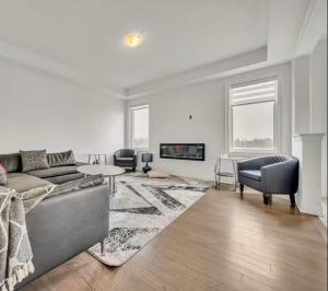a living room with a couch and a table at Cambridge Luxury by Ravine in Cambridge