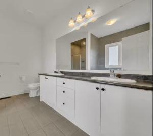 a white bathroom with a sink and a toilet at Cambridge Luxury by Ravine in Cambridge +34 photos
