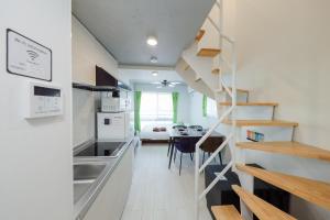 a kitchen with a staircase leading to a living room at RECO Waseda in Tokyo +150 photos