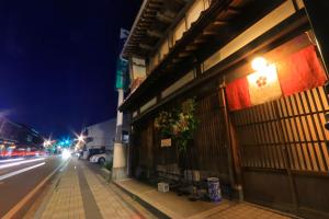 a building on the side of a street at night at 龍助25ANNEX Ryusuke25ANNEX in Komatsu +84 photos