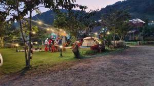 a group of people standing in a yard with a tent at อินทนนท์ บ้านพักเล่าจู Inthanon Laoju House in Ban Na Yang +4 photos