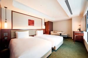 Postel nebo postele na pokoji v ubytování Marunouchi Hotel