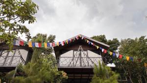 a building with a banner with flags on it at Lilys Stone Garden Bungalow in Tram de Dak Mil +9 photos