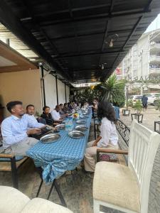 a group of people sitting at a long table at Kk Hotel in Addis Ababa