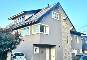 a house with a car parked in front of it at Departamento completo en San Carlos de Bariloche, Argentina in San Carlos de Bariloche