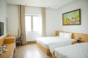 Postel nebo postele na pokoji v ubytování Min Min Hotel