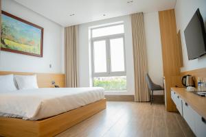 Postel nebo postele na pokoji v ubytování Min Min Hotel