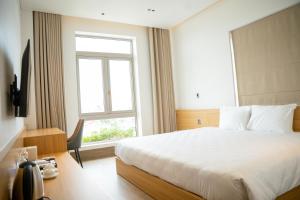 Postel nebo postele na pokoji v ubytování Min Min Hotel