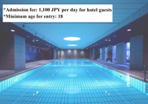 a large swimming pool in a building with a quote at Hotel Granvia Kyoto in Kyoto