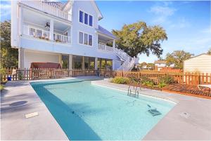 a house with a swimming pool in front of a house at Luxury Beachside Haven with Pool and Elevator in Long Beach