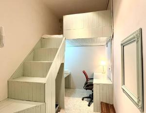 a room with a staircase with a desk and a mirror at Kim Haus Loft in George Town